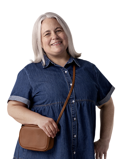 Aly, a person living with XLH, standing and smiling while holding her purse