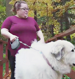 Karen, a person living with XLH, walking her dog
